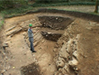 Click to enlarge image of John Roberts standing in the inner ditch in Trench 18